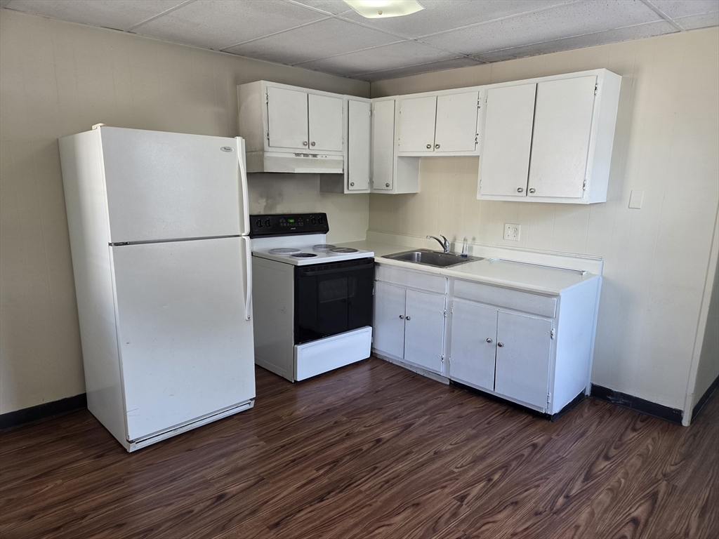 2038-2046 Main Street, Unit 2 Three Rivers, MA 01080 - Photo 1 of 18 a kitchen with wooden floors and white stainless steel appliances
