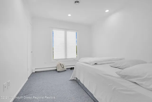 a bed room with a bed and a window