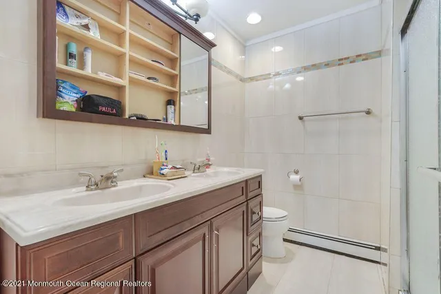 a bathroom with a sink a toilet and a mirror