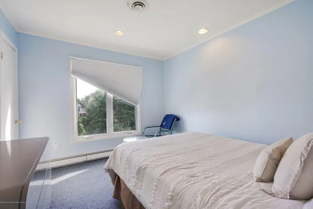 a bedroom with a large bed and a large window