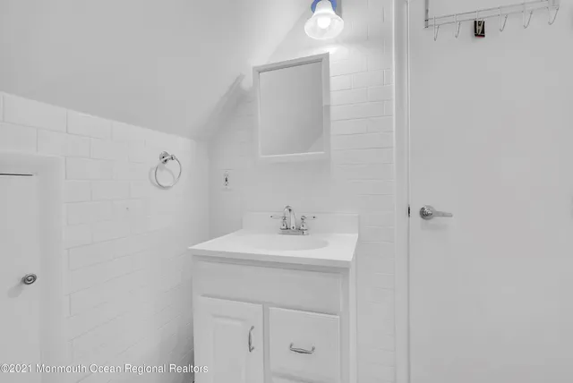 a bathroom with a sink a mirror and vanity