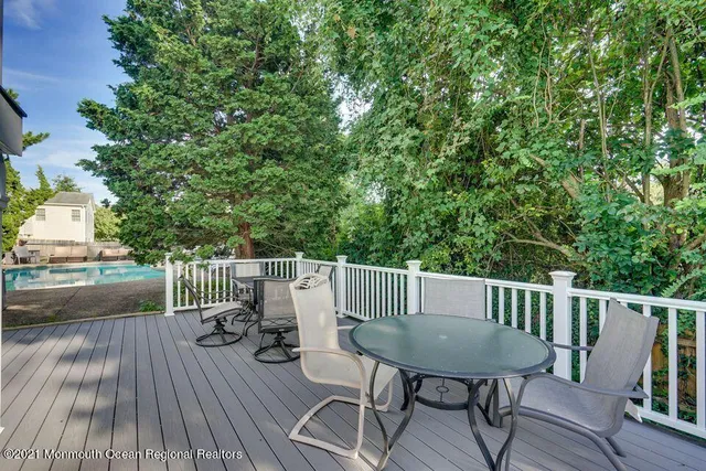 a view of a deck with furniture and wooden floor