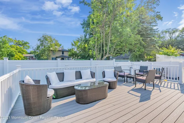 a view of roof deck with dining table and chairs
