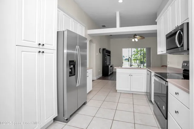 a kitchen with cabinets and stainless steel appliances