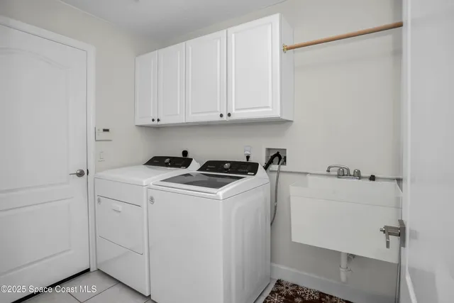 a spacious bedroom with a bed and a chandelier