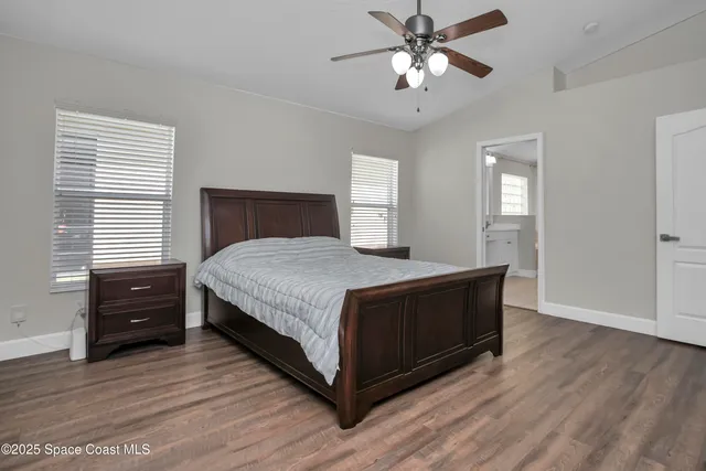 a bedroom with a bed and a television