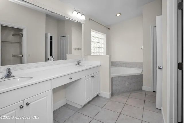 a bathroom with a sink vanity and mirror
