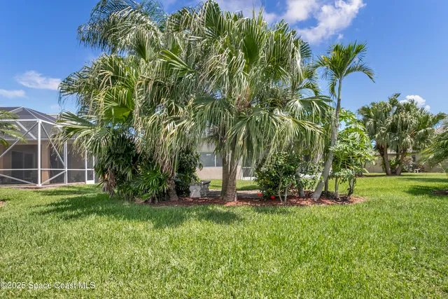 an aerial view of residential houses with outdoor space and lake view