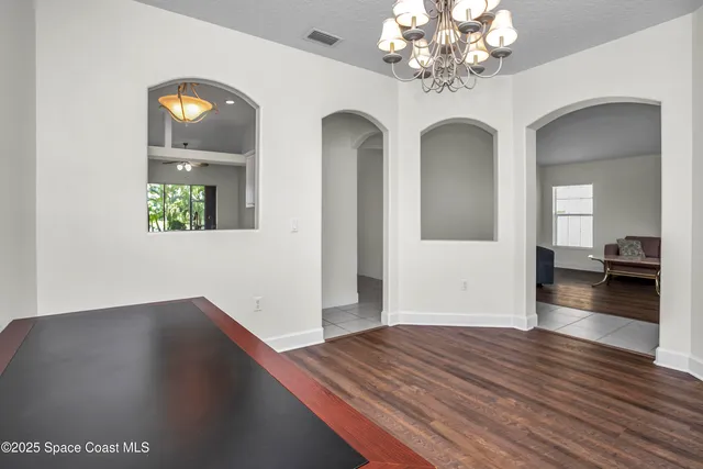 a kitchen with white cabinets and appliances