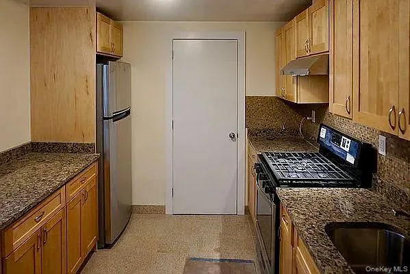 a kitchen with a stove and a refrigerator