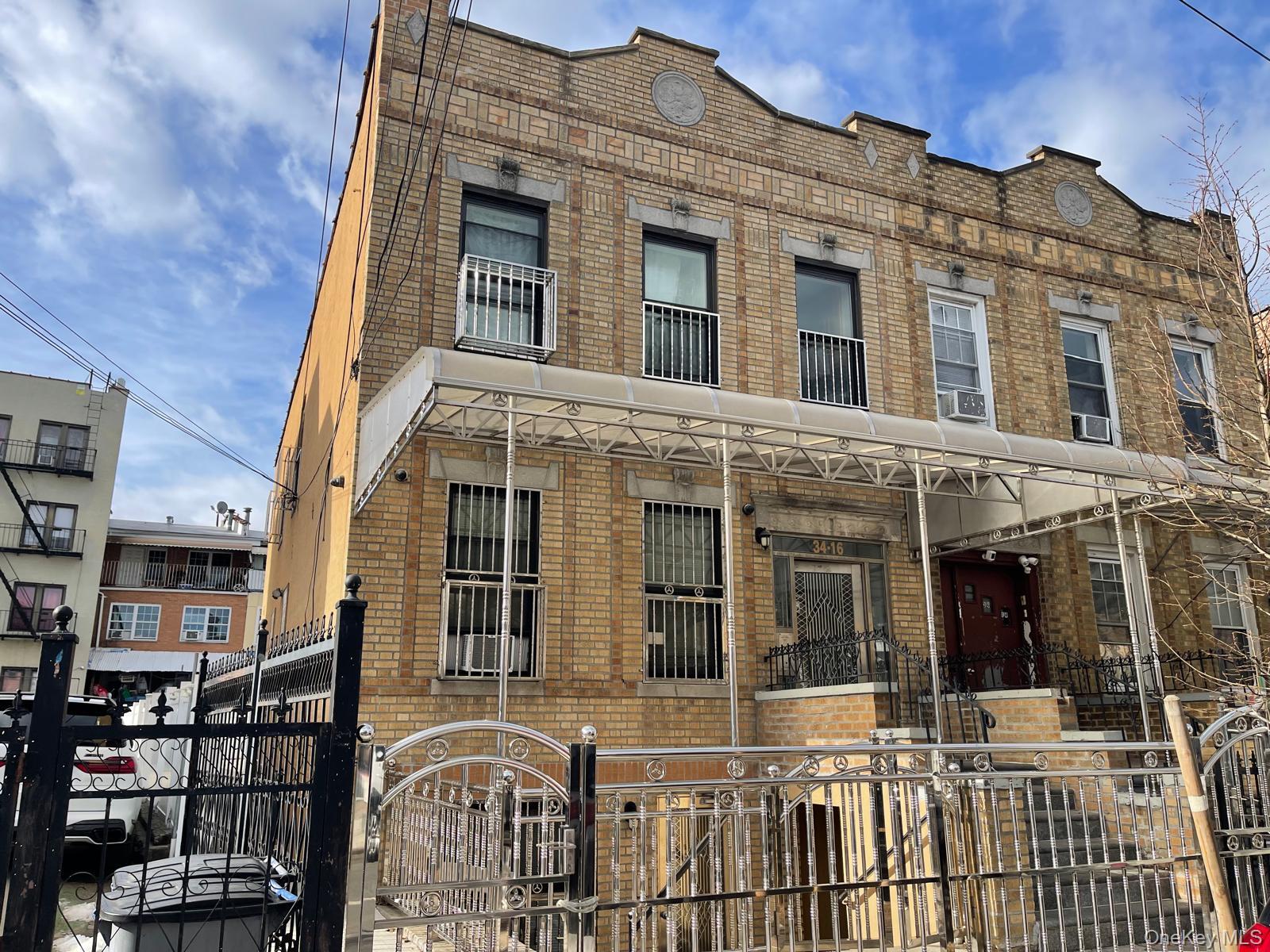 34-16 103rd Street Queens, NY 11368 - Photo 2 of 2 a front view of a building with glass door