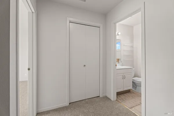a bathroom with a sink mirror and toilet