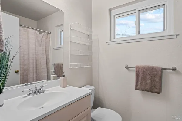 a view of a chairs and table in the back yard of the house