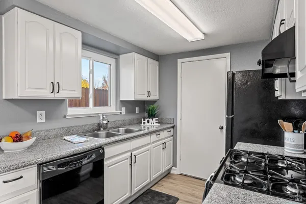 a kitchen with a sink stove and refrigerator