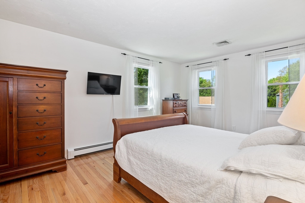 6 Wight Farm Road Natick, MA 01760 - Photo 20 of 37 a bedroom with a bed and a flat screen tv