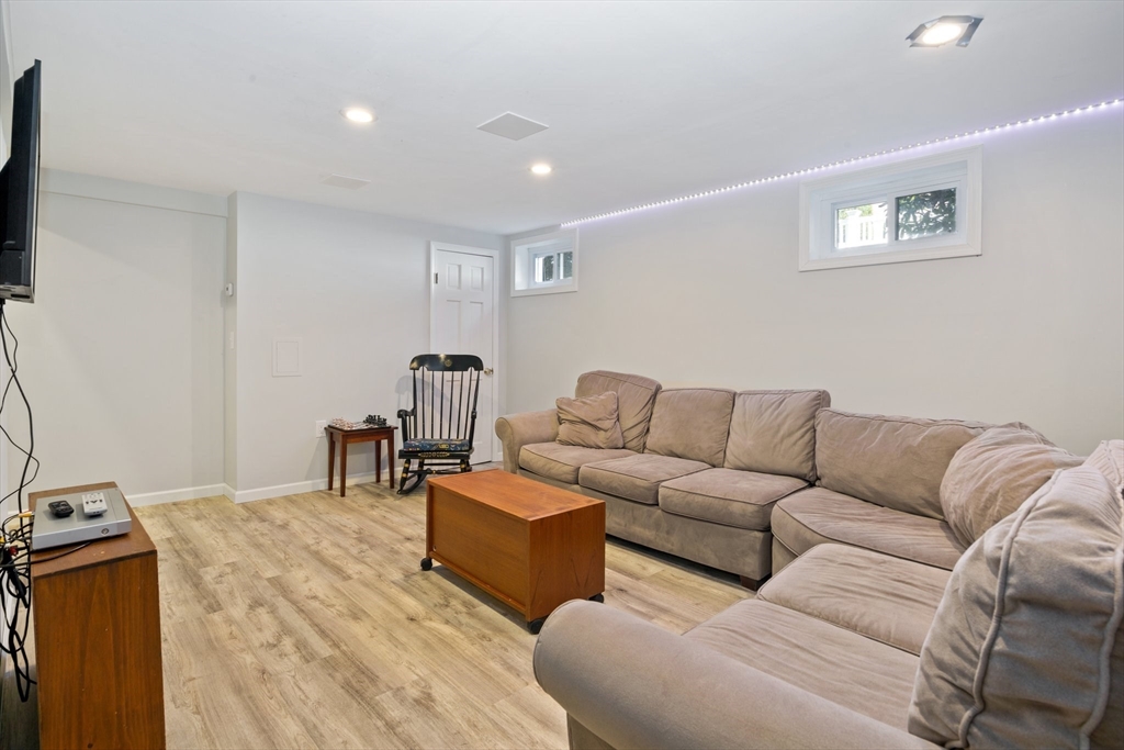 6 Wight Farm Road Natick, MA 01760 - Photo 26 of 37 a living room with couches and a flat screen tv