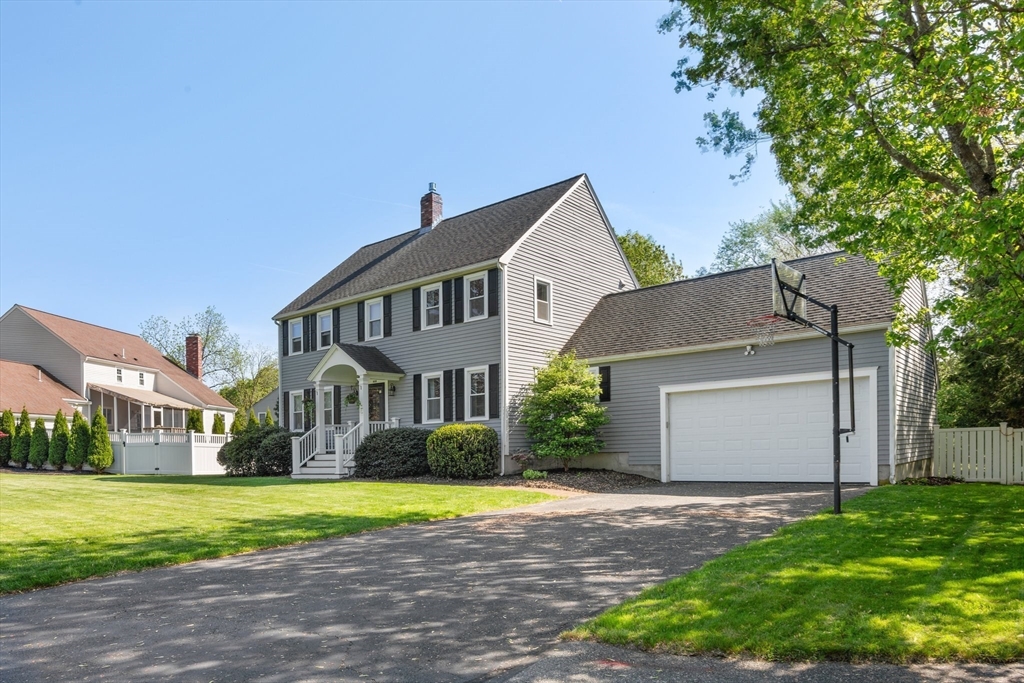 6 Wight Farm Road Natick, MA 01760 - Photo 33 of 37 a view of a white house next to a yard with big trees