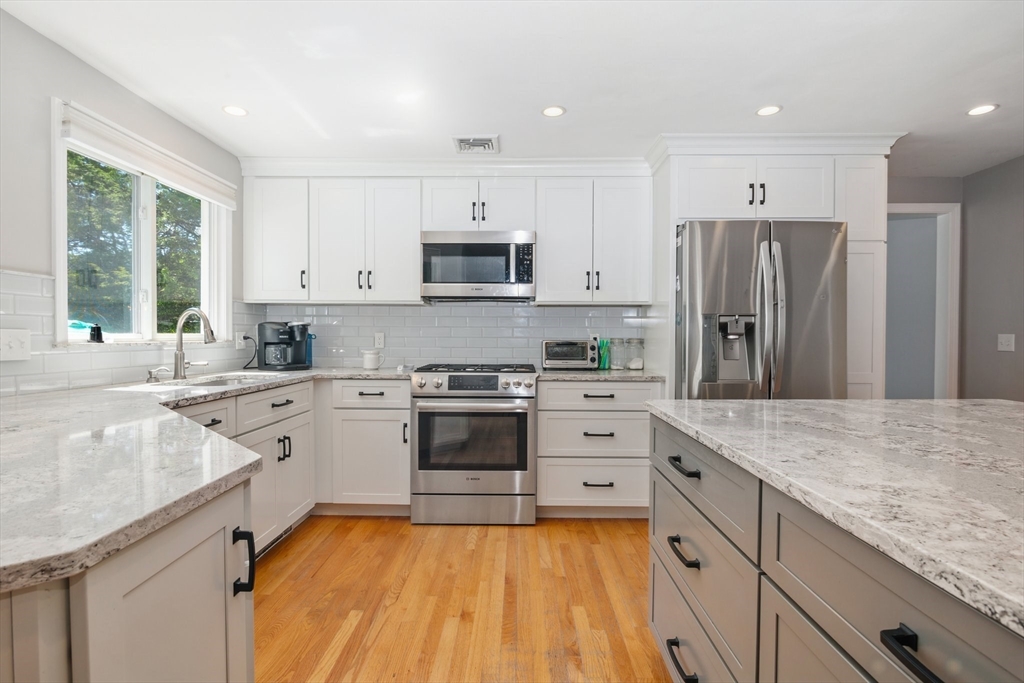 6 Wight Farm Road Natick, MA 01760 - Photo 4 of 37 a kitchen with stainless steel appliances granite countertop a stove refrigerator sink and cabinets