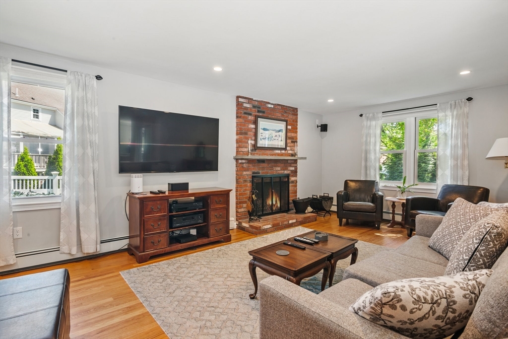 6 Wight Farm Road Natick, MA 01760 - Photo 6 of 37 a living room with furniture a flat screen tv and a fireplace