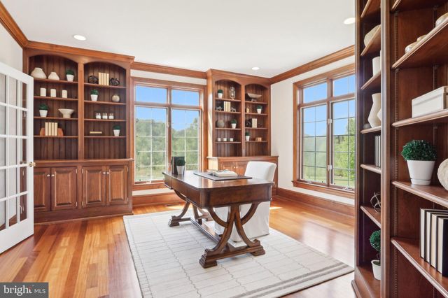 a kitchen with stainless steel appliances granite countertop a sink a stove and a wooden cabinets
