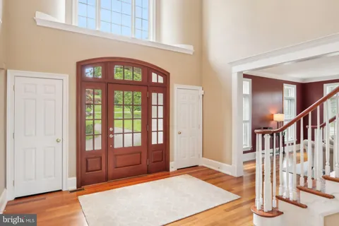a living room with furniture a bookshelf and a large window