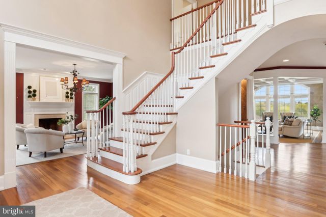 a living room with furniture a bookshelf and a large window