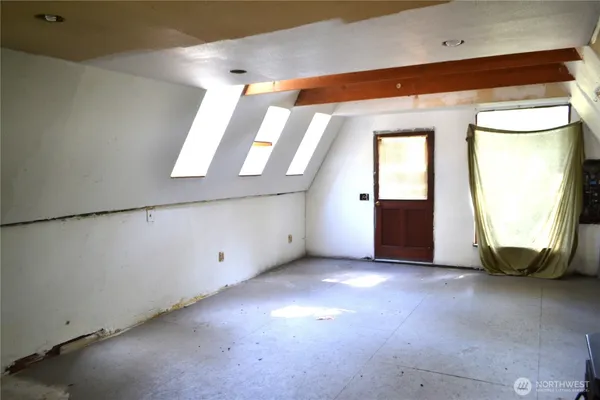 a view of an empty room with a window