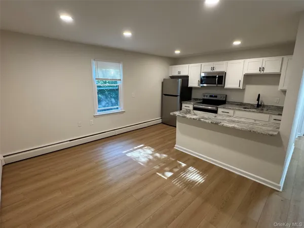 a kitchen with stainless steel appliances a refrigerator sink and microwave