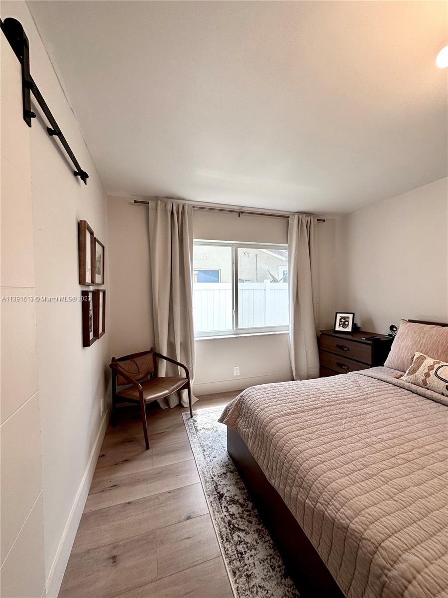 8949 Southwest 9th Street Boca Raton, FL 33433 - Photo 29 of 46 a bedroom with a bed and a window