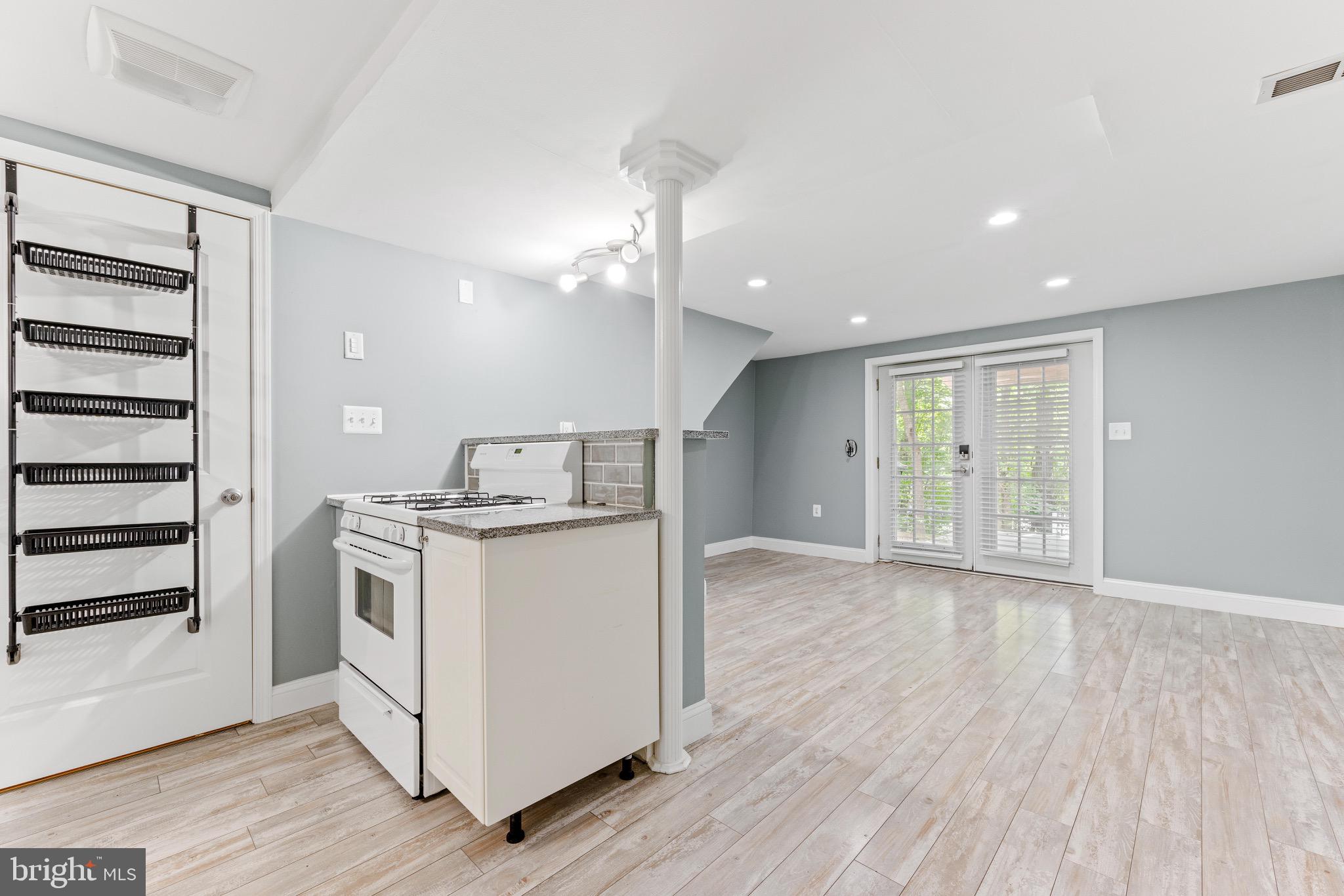 7140 Stone Throw Way Elkridge, MD 21075 - Photo 3 of 9 a view of a kitchen with furniture and wooden floor