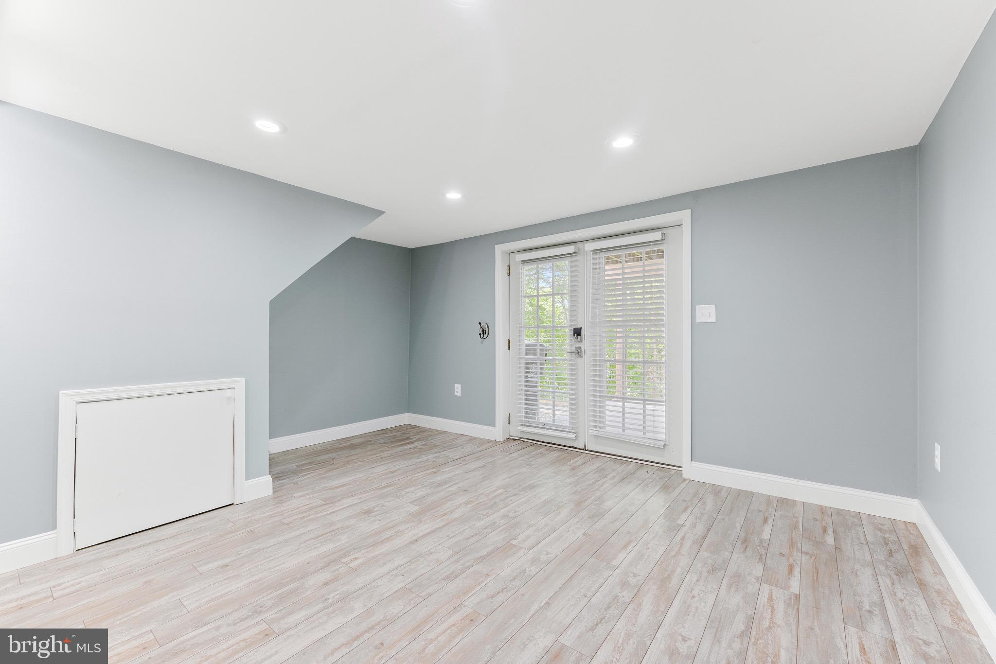 7140 Stone Throw Way Elkridge, MD 21075 - Photo 4 of 9 a view of an empty room with wooden floor and a window