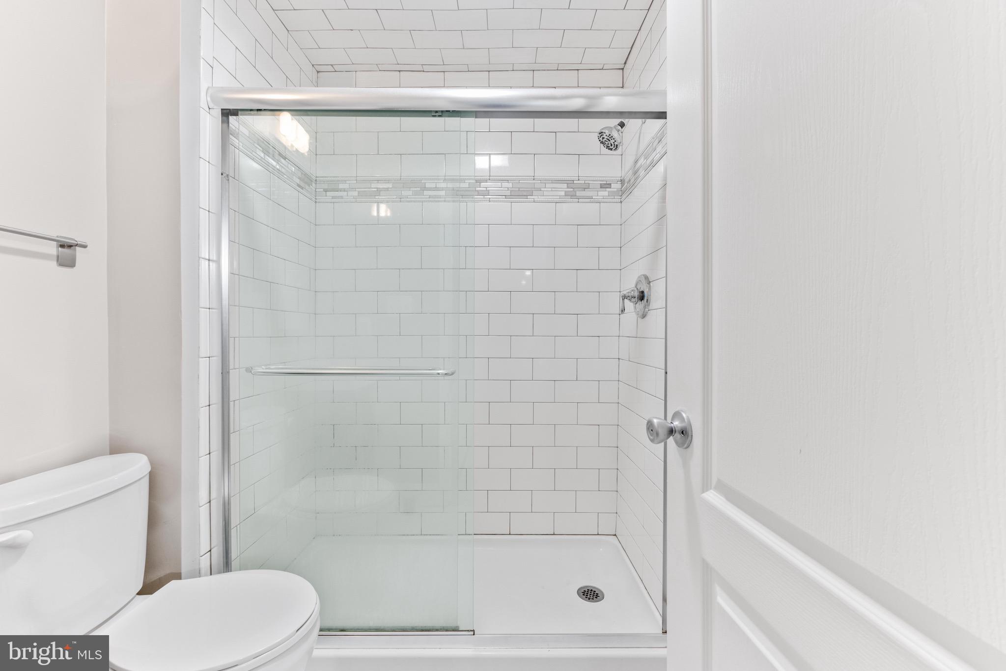 7140 Stone Throw Way Elkridge, MD 21075 - Photo 9 of 9 a bathroom with a shower a toilet and a sink