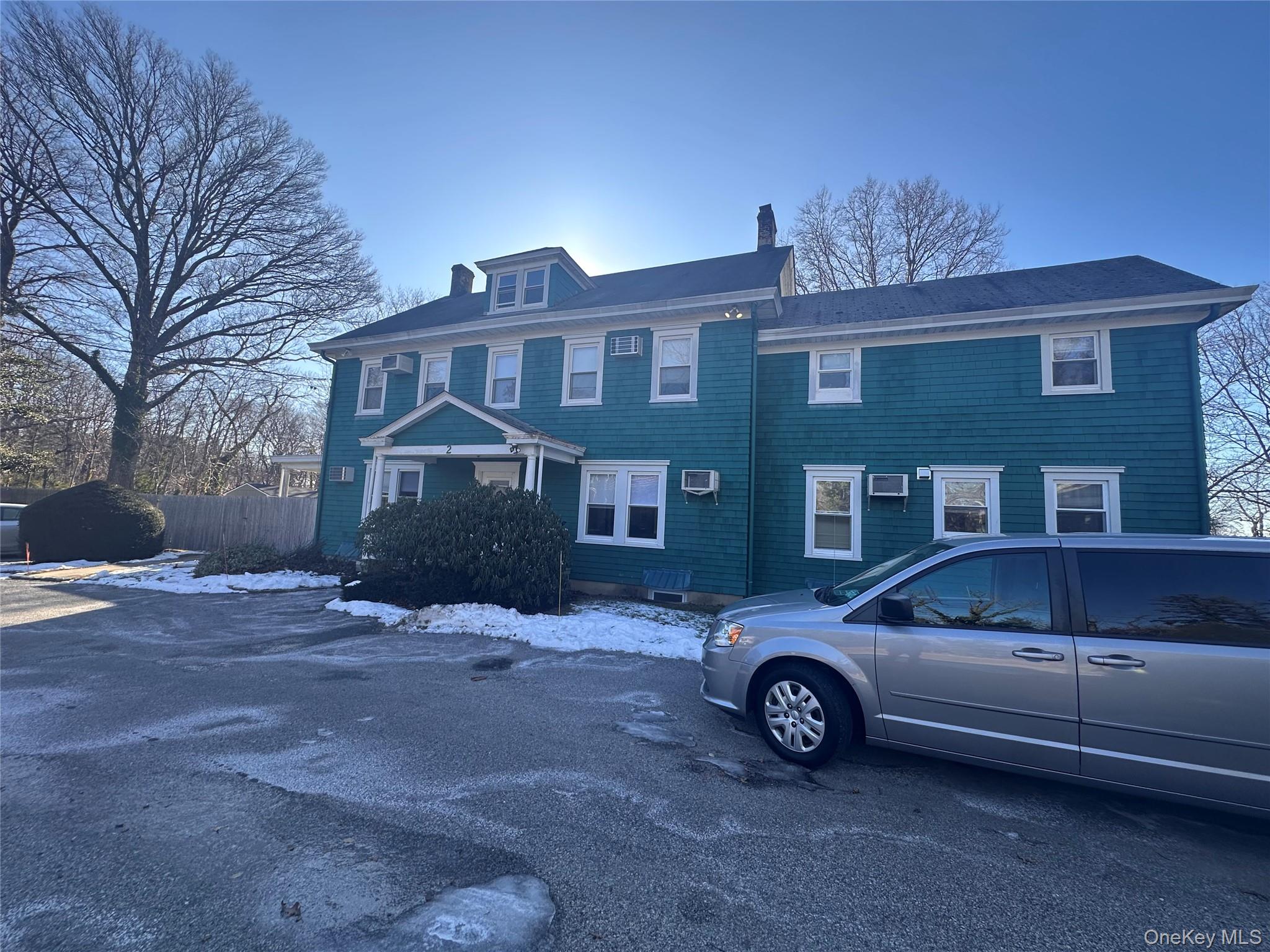 a front view of a house with parking space