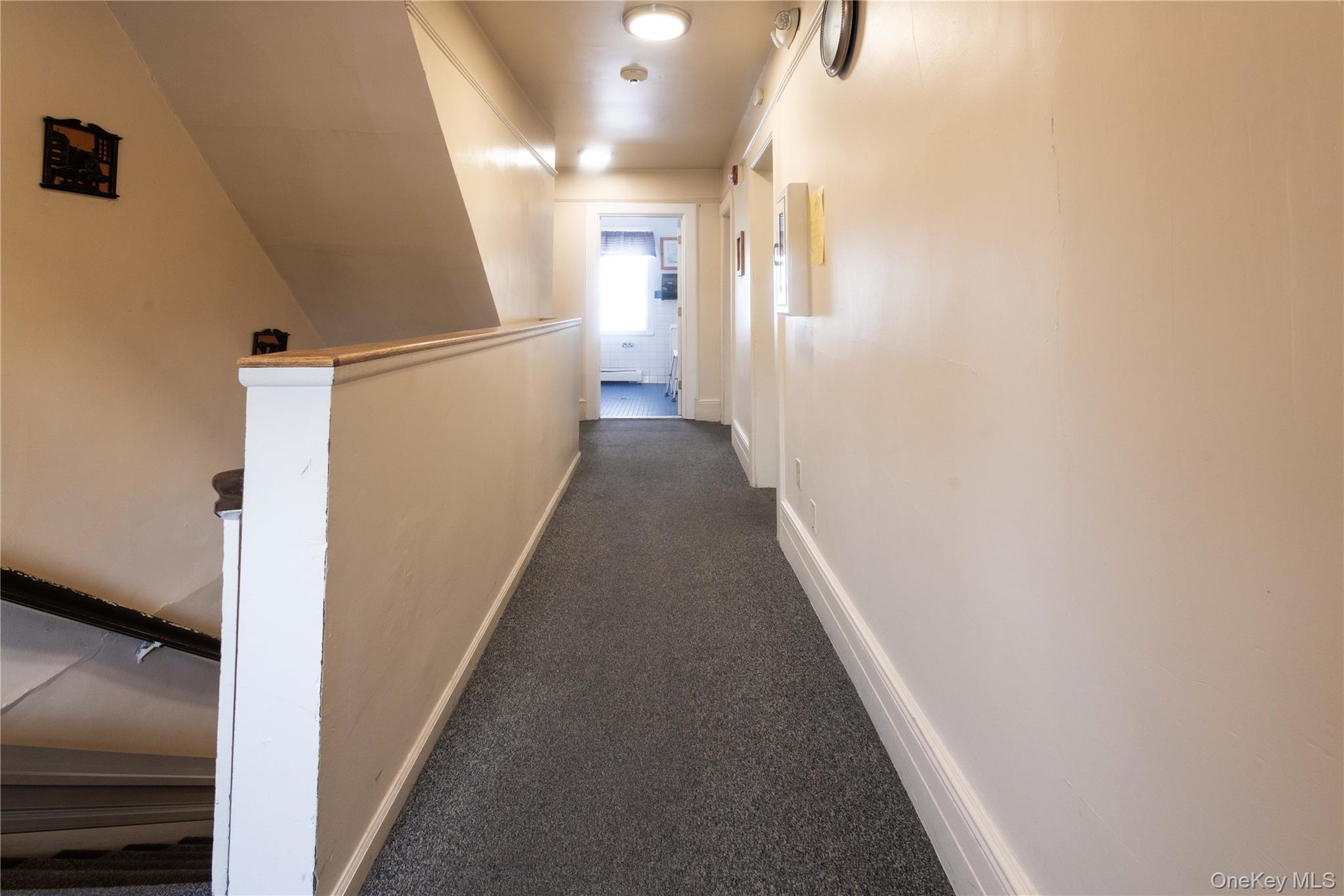 2 Old Cedar Swamp Road Jericho, NY 11753 - Photo 23 of 30 a view of a hallway with wooden floor and staircase