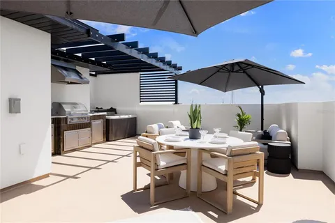 a room with stainless steel appliances kitchen island granite countertop furniture and a kitchen view