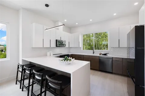 a kitchen with a sink a stove and cabinets
