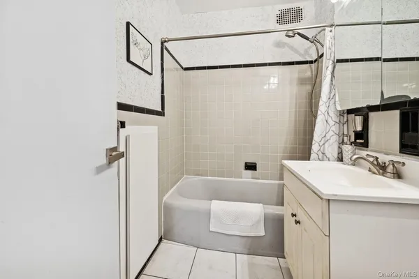 a bathroom with a sink a mirror and a shower