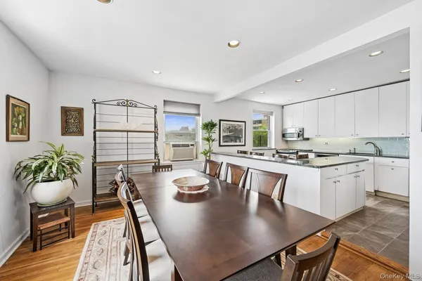 a large kitchen with a table chairs and flat screen tv