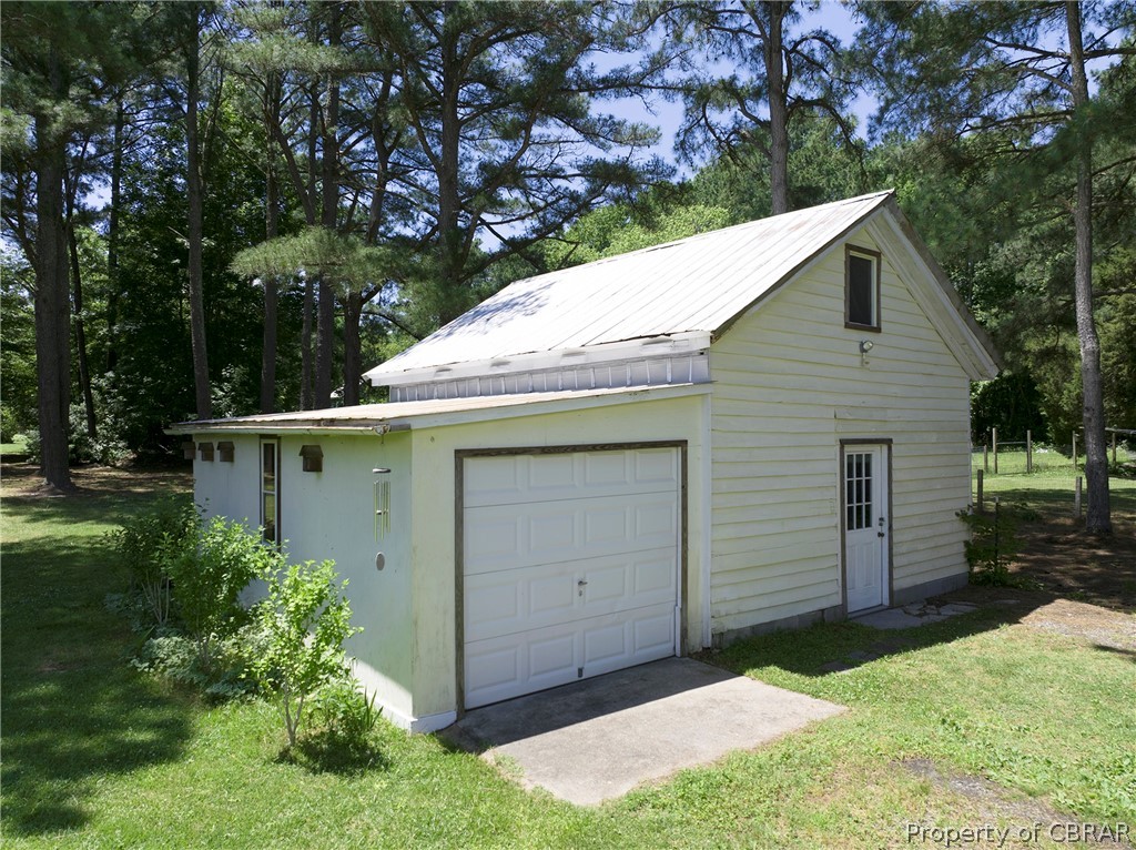 2442 Old Ferry Road Hudgins, VA 23076 - Photo 14 of 33 Garage featuring a lawn