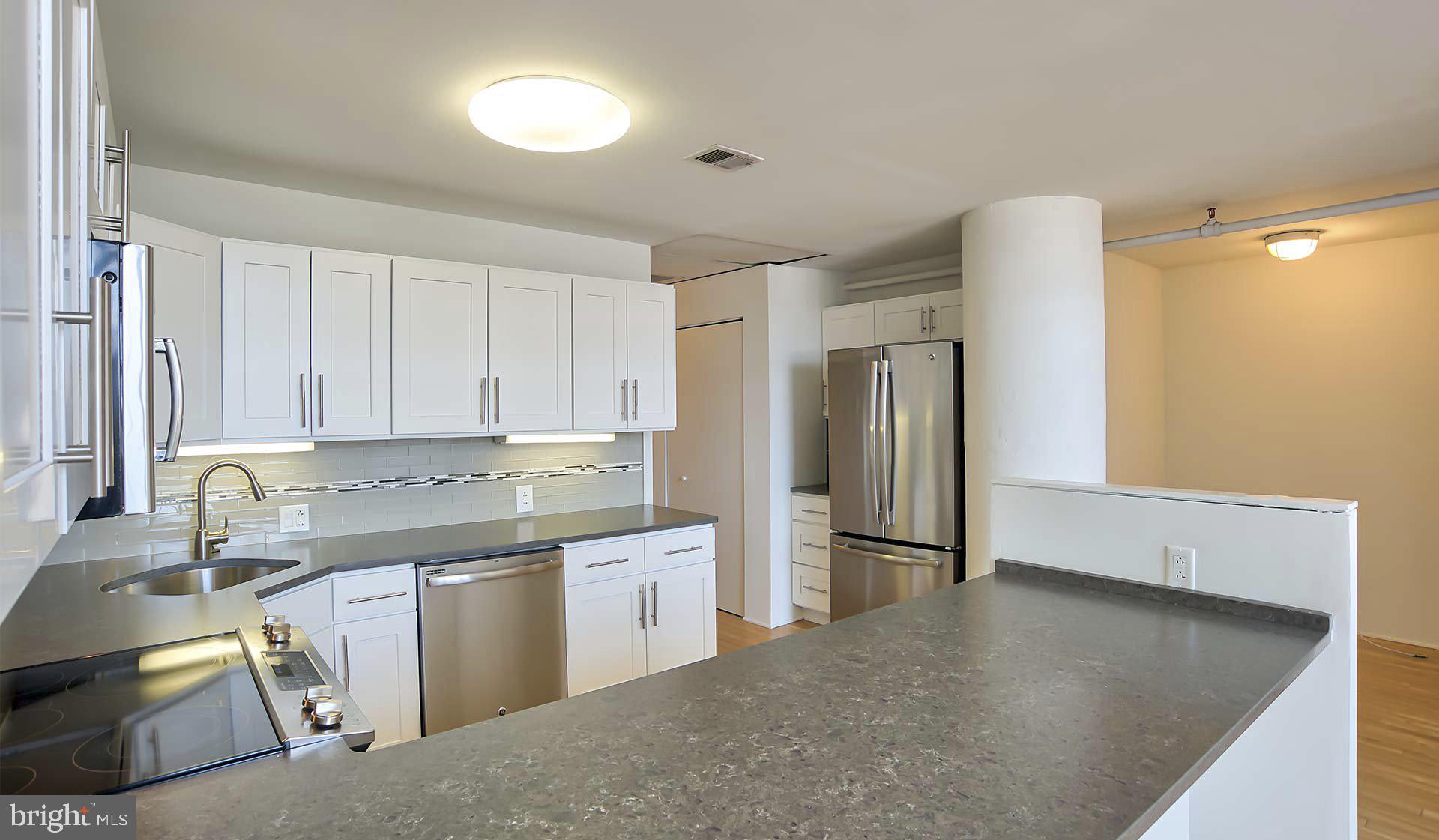 2300 Walnut Street, Unit 515 Philadelphia, PA 19103 - Photo 21 of 27 a kitchen with stainless steel appliances granite countertop a sink stove and refrigerator