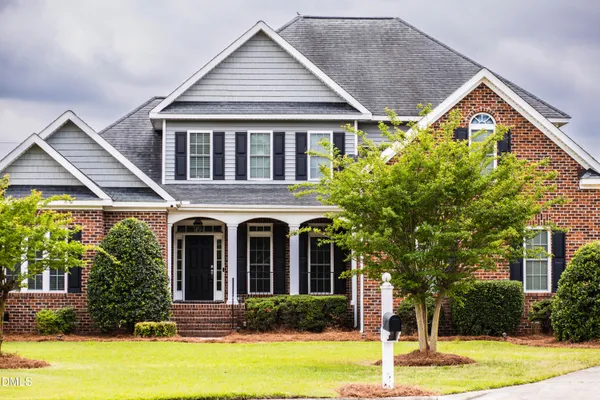 a front view of a house with a yard