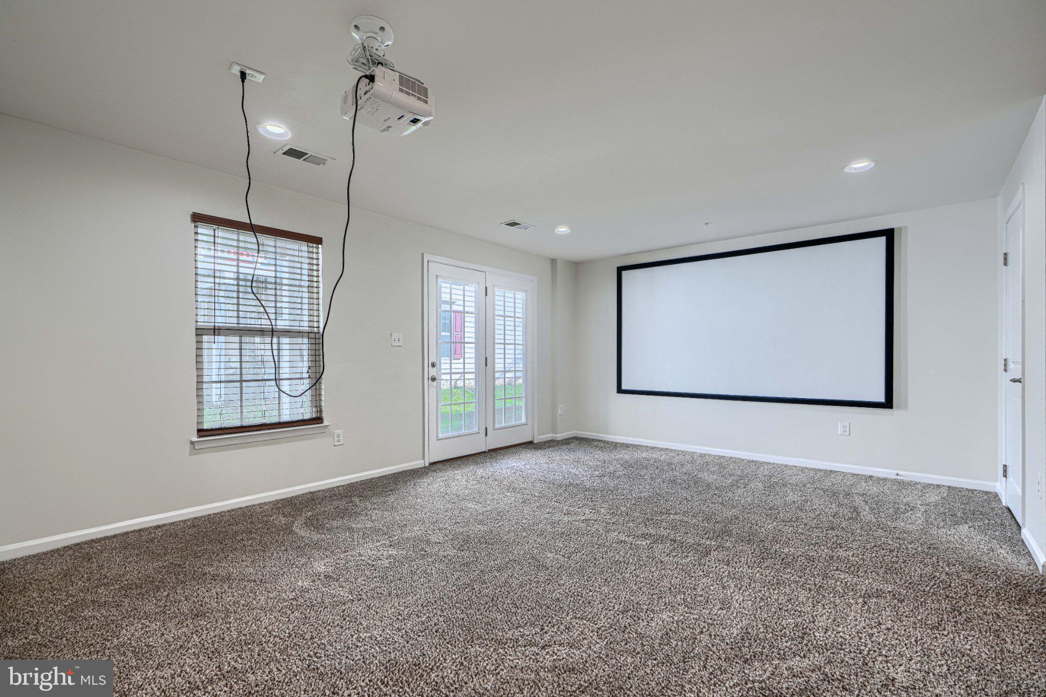 7336 Summit Rock Road Elkridge, MD 21075 - Photo 4 of 46 Spacious media room with projector setup.