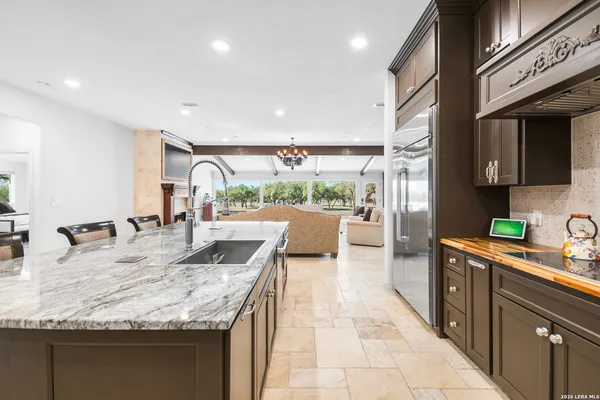 a kitchen with stainless steel appliances granite countertop a sink and a microwave