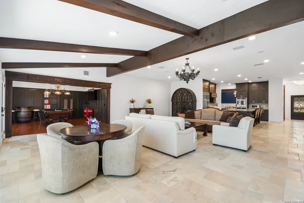 a living room with furniture and kitchen view