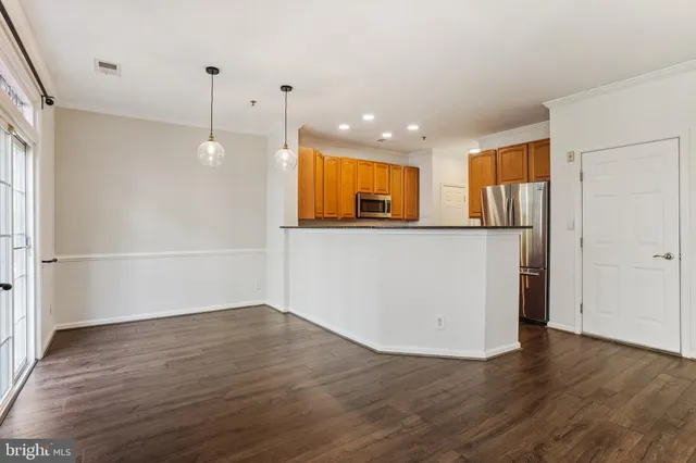 a view of kitchen with wooden floor and window