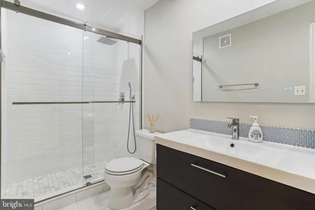 a bathroom with a sink toilet and shower