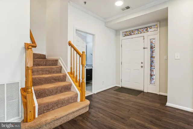 a view of entryway and hall with wooden floor
