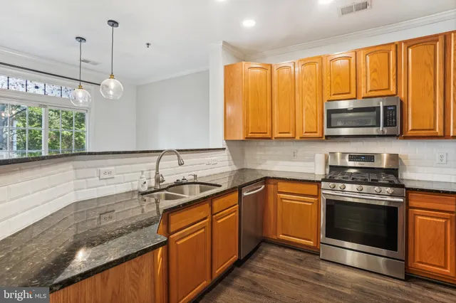 a kitchen with a sink stove and microwave