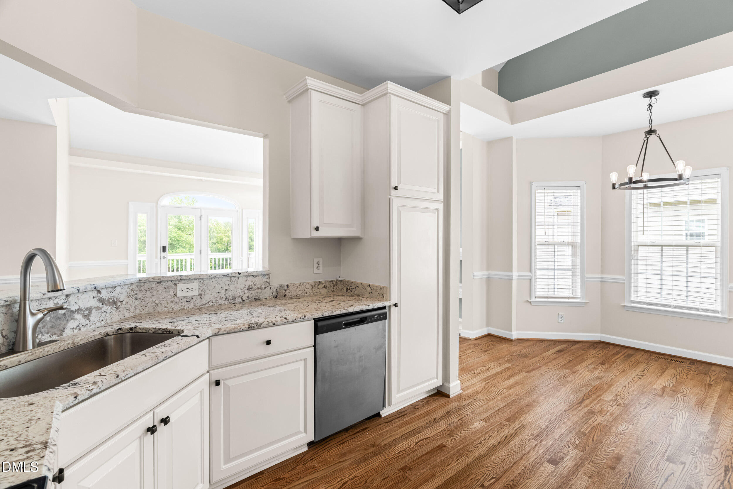 744 Seastone Street Raleigh, NC 27603 - Photo 24 of 53 a kitchen with granite countertop a sink cabinets and wooden floor