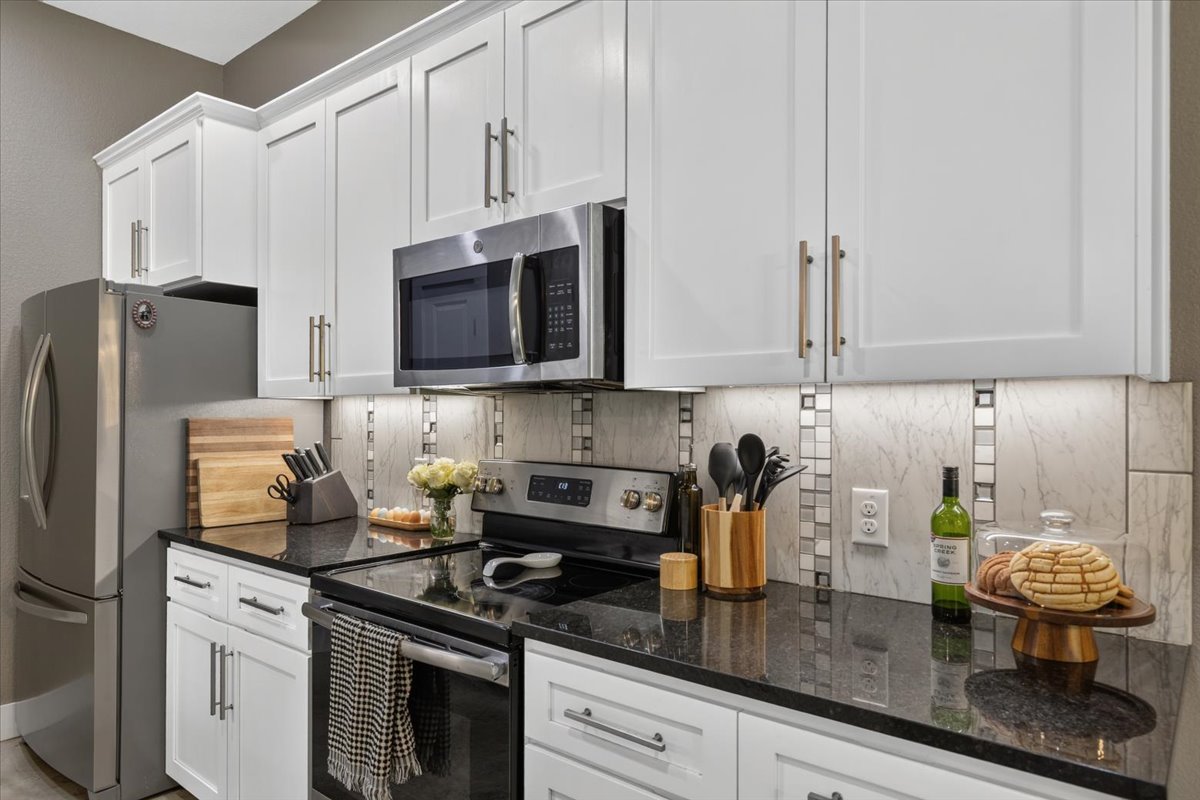 145 Cardinal Loop Paige, TX 78659 - Photo 15 of 40 Granite counters and stainless steel appliances adorn this efficient culinary space.